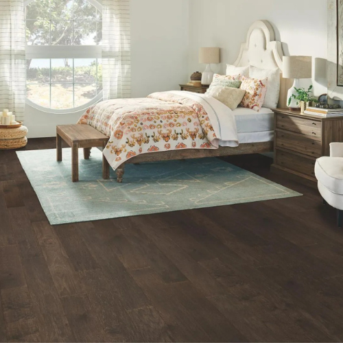 hardwood flooring in bedroom, wood desk, area rug